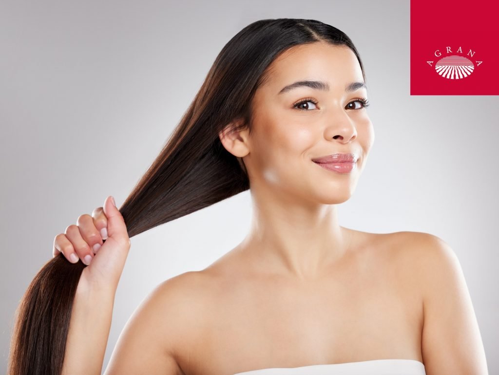 Image shows woman holding her hair for the cover of Agrana